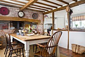 Rustic dining area with wooden table, fireplace and country-style decorations