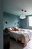 Bedroom with double bed, wall lights and white ceiling lamp