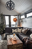 Living room decorated for Christmas with rustic coffee table