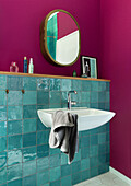 Bathroom with turquoise-colored tiles and magenta-colored walls