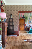 Leopard pattern wallpaper in vintage living room with wooden furniture