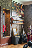 Music corner with red electric guitar and amplifier in front of leopard print wallpaper