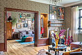 Living room with leopard print wallpaper and eclectic furnishings