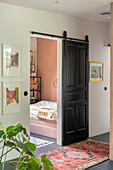 Country-style sliding door, view of bedroom with terracotta wall