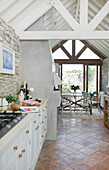 Open-plan living room with kitchen and dining room, terracotta floor