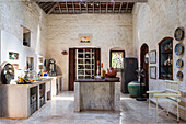 Rustic-style kitchen with exposed beams and plastered stone walls
