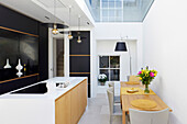 Modern open kitchen with skylight and dining table