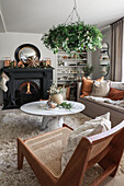 Cosy living room with winter decoration and open fireplace