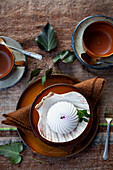 Table setting with dessert in a shell dish and teacups