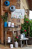 Corner on patio with Summer party sign, flowers and decorations