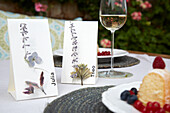 Table setting with DIY name tags, cake and wine glass