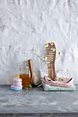 Care for skin and hair: oil bottle, cream jar, cotton pads, wooden comb and chamomile sprig