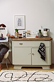 Vintage chest of drawers, next to it a woman with a magazine