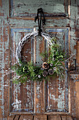 Christmas wreath on old wooden door with peeling paint