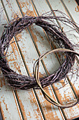 Three handmade wreath bases made from twigs on a wooden background