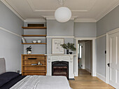 Bedroom with fireplace, grey walls and an ensuite bathroom