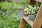 Bouquet of lily of the valley on a wooden ladder