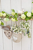 Spring decoration with smooth hydrangea, daisies, lily of the valley, and forget-me-nots