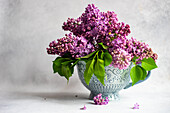 Purple lilac bouquet in a vase