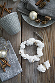 Wreath made of cotton, napkin, cinnamon, larch cones, and Christmas ornaments