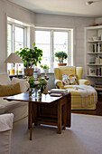Living room with upholstered sofa, folding coffee table, and yellow wingback chair