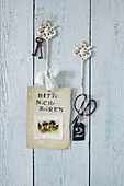 A homemade 'Bitte nicht stören' (Please do not disturb) sign on old-fashioned wall hooks