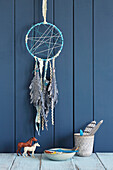 Dream catcher made from jeans fabric remnants with feathers