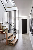 An entrance and a stairway of a modern home with a study nook