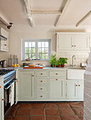 Light country kitchen with terracotta floor
