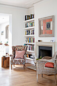 Armchair in front of the fireplace and bookshelf in the study