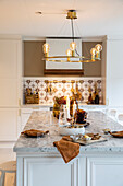 Breakfast set with brown accents on kitchen island with marble countertop