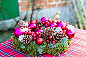 Christmas wreath decorated with baubles on a chequered tablecloth