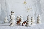 DIY fir trees made of book pages and wooden deer figurines
