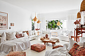 White seating furniture, Moroccan cushions and tables in the living room