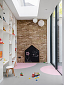 Children's playroom with floor-to-ceiling shelving, brick wall and sliding glass door