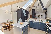 Center kitchen island in a bright, open kitchen with skylight