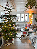 Illuminated Christmas tree and cat in farmhouse style living room
