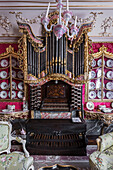 Victorian plates surround organ with walls in Raspberry silk
