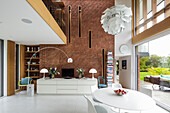 Luxurious open plan living room with brick wall and window frontage