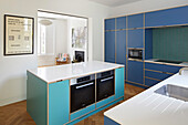 Modern kitchen with blue cabinet fronts made of multiplex boards