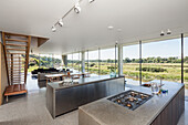 Modern open plan kitchen and living room with floor to ceiling windows