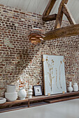 Shelf with decorative objects against brick wall