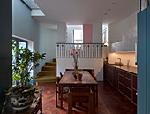 Fitted kitchen and dining area with staircase in background in renovated house