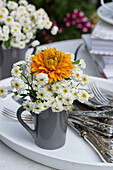 Echinacea and bergamot bouquet on tray with cutlery