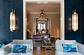 Day beds, above them wall sconces in blue room