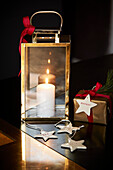 Lantern with candle and star-shaped gift tags