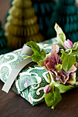 Christmas wrapping decorated with a hellebore