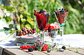 Stem glass filled with berries, as table decoration