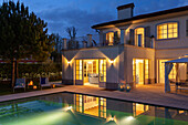 Illuminated villa with pool