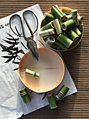 A bowl of bamboo tubes and a pair of vintage scissors
